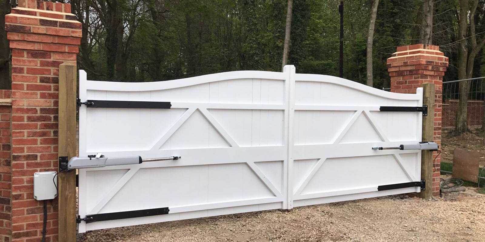 Automatic Gates - above ground automation on white wooden gates